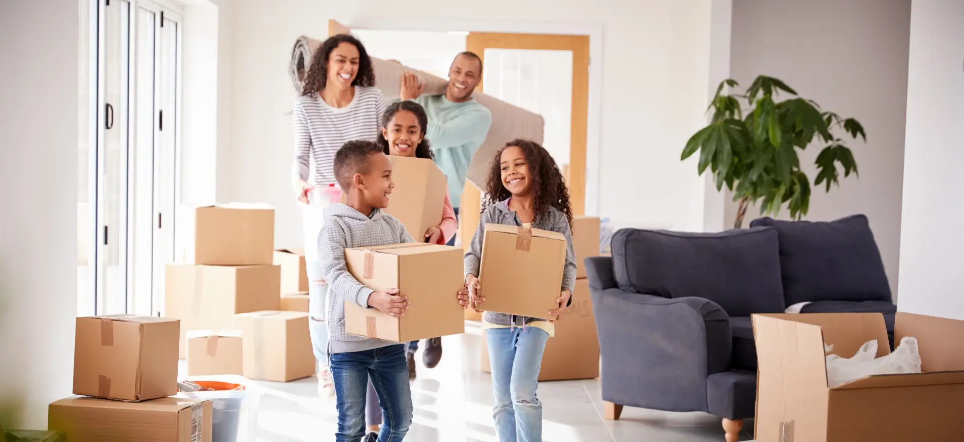 Happy family moving in to their new home thanks to Greene Light Home Loans